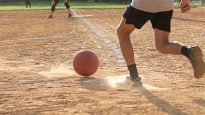player kicking ball for kickball
